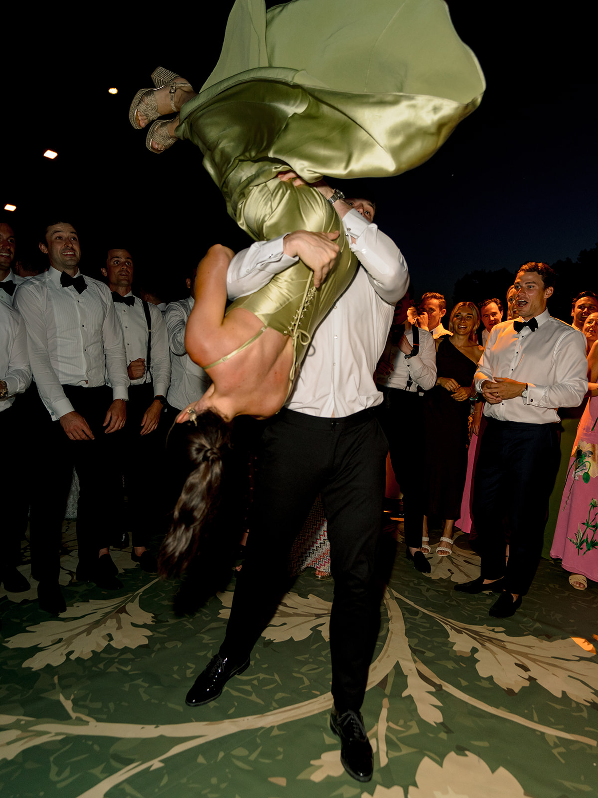 Wedding guest lifted upside down during an energetic dance floor moment at Villa Baulieu